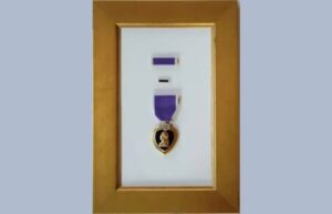 Custom framing for a medal with a blue tag